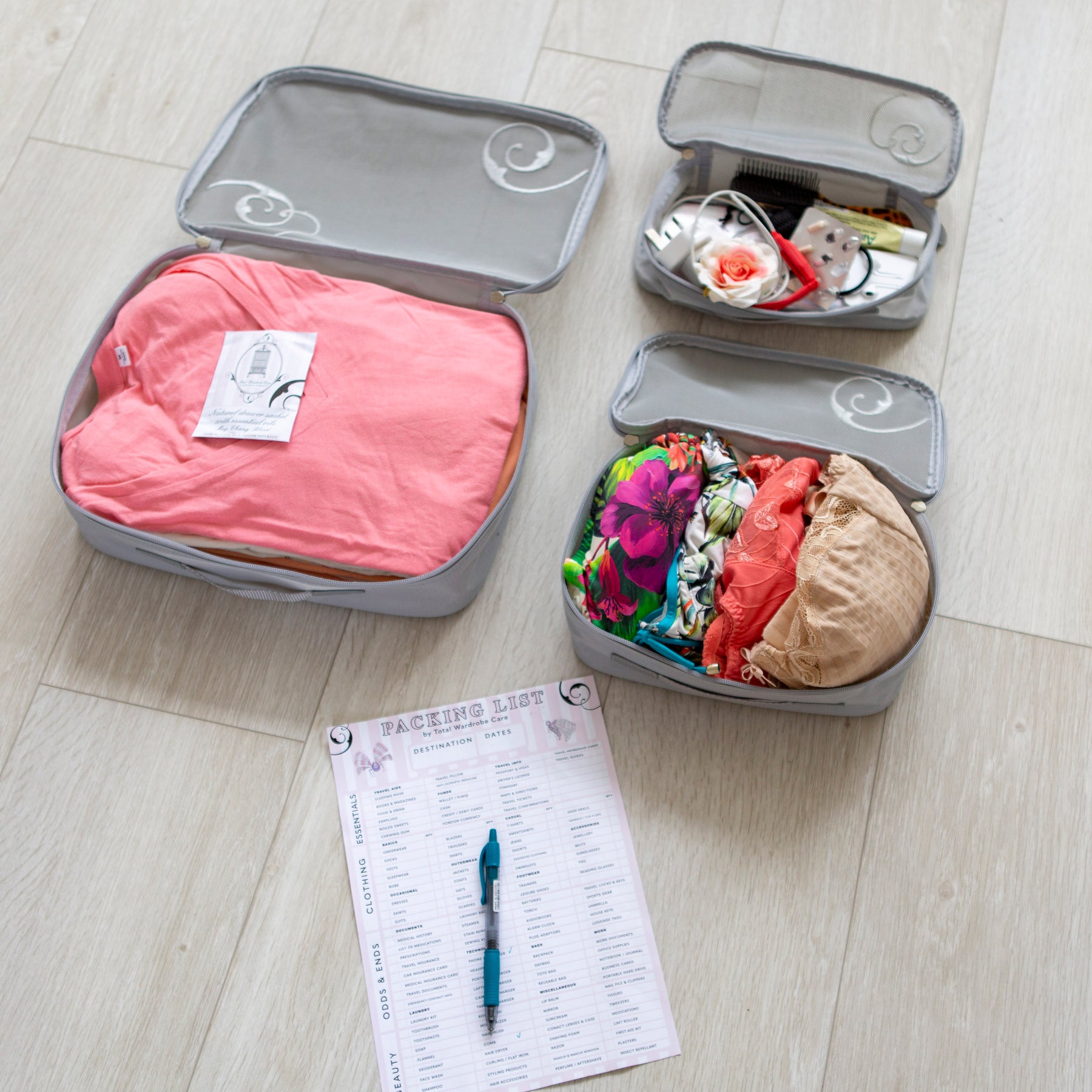 3 travel packing cubes open showing colourful holiday garments beside packing list