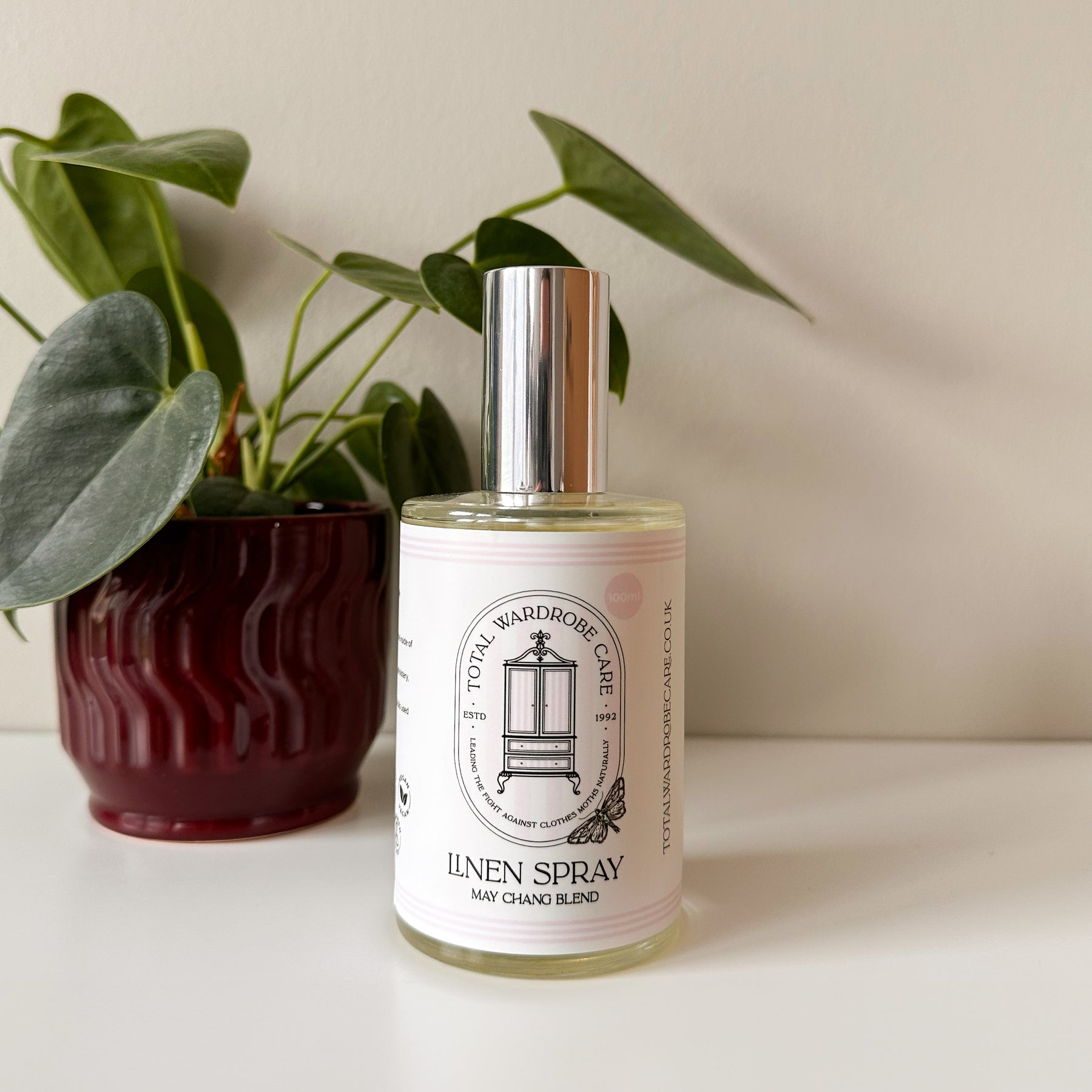 May Chang linen spray with fresh branding beside small plant pot