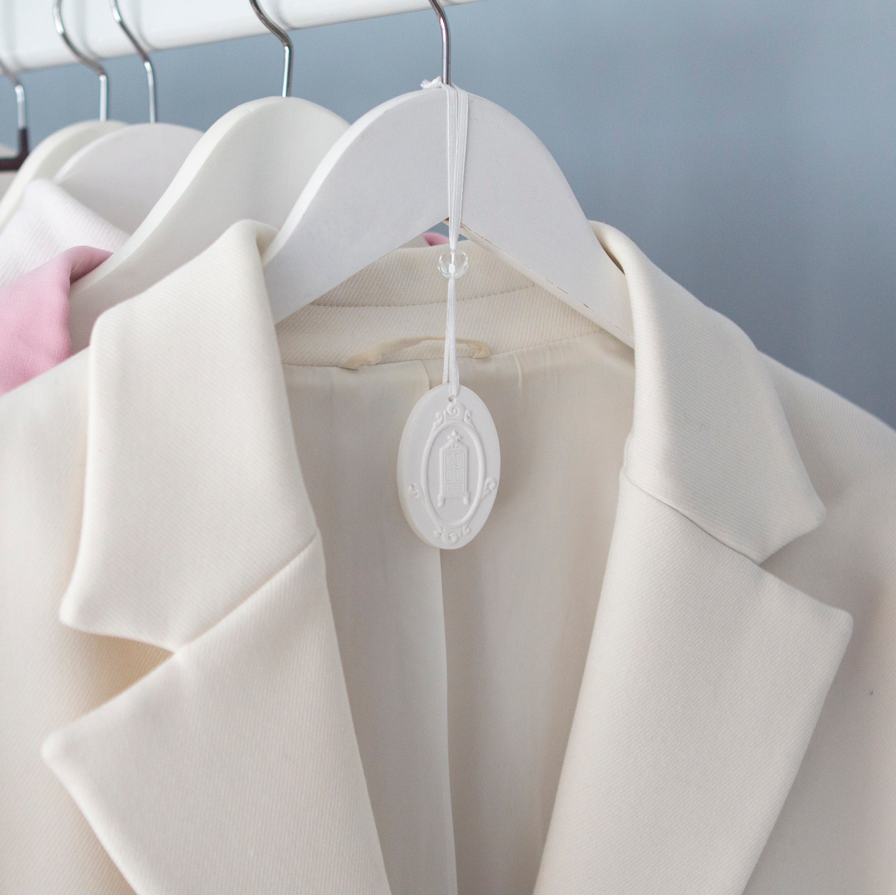 Ceramic hanger hanging from wardrobe railing