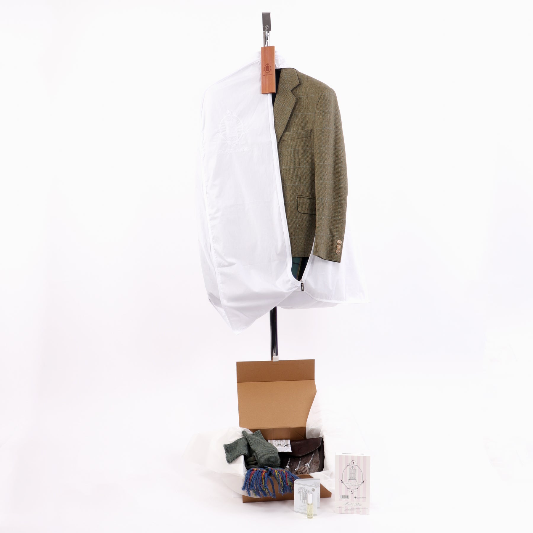 Open clothing care bag with tweed jacket showing from side view and kilt care kit to bottom