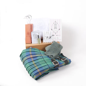 Folded kilt beside kilt care kit box with range of anti-moth products lined on top