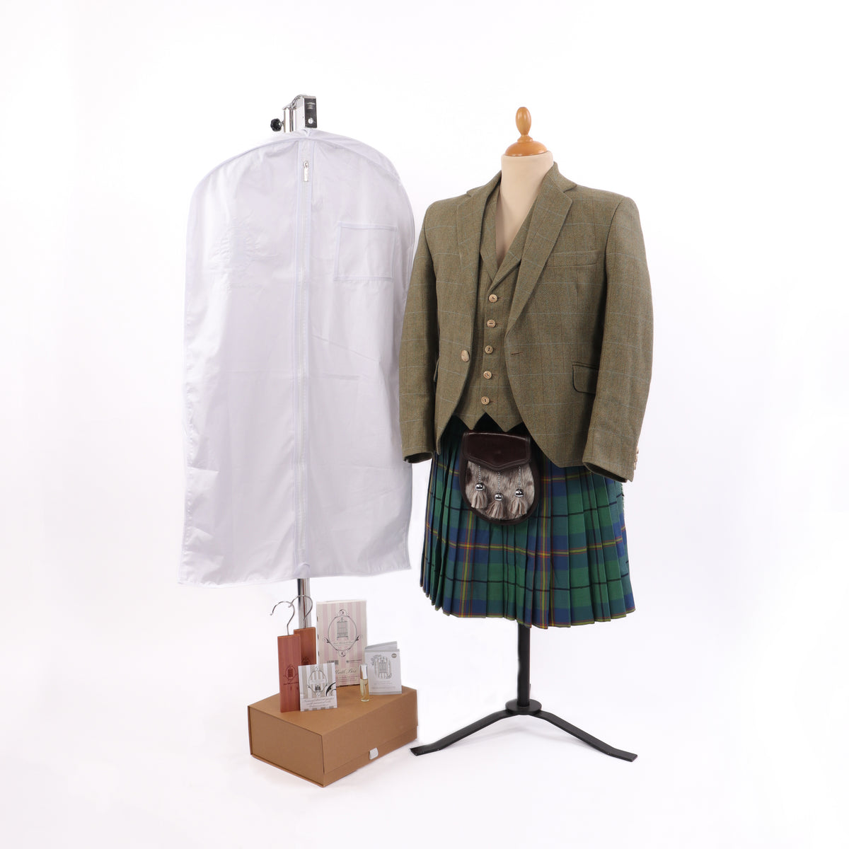 Hanging white clothing storage bag beside model stand in Scottish clothing