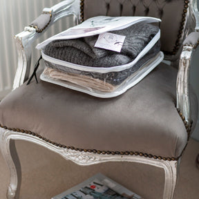 Open Knitwear & T-Shirt Storage bag on grey and silver armchair with grey jumper to interior