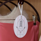 Total Wardrobe Care hanging oval hanging from burgundy hanger extension