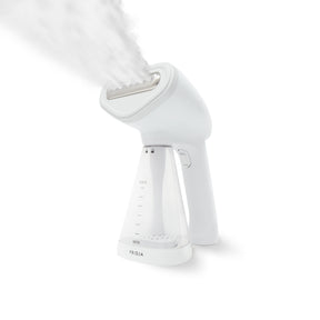 Fridja Handheld steamer in white expelling steam from front