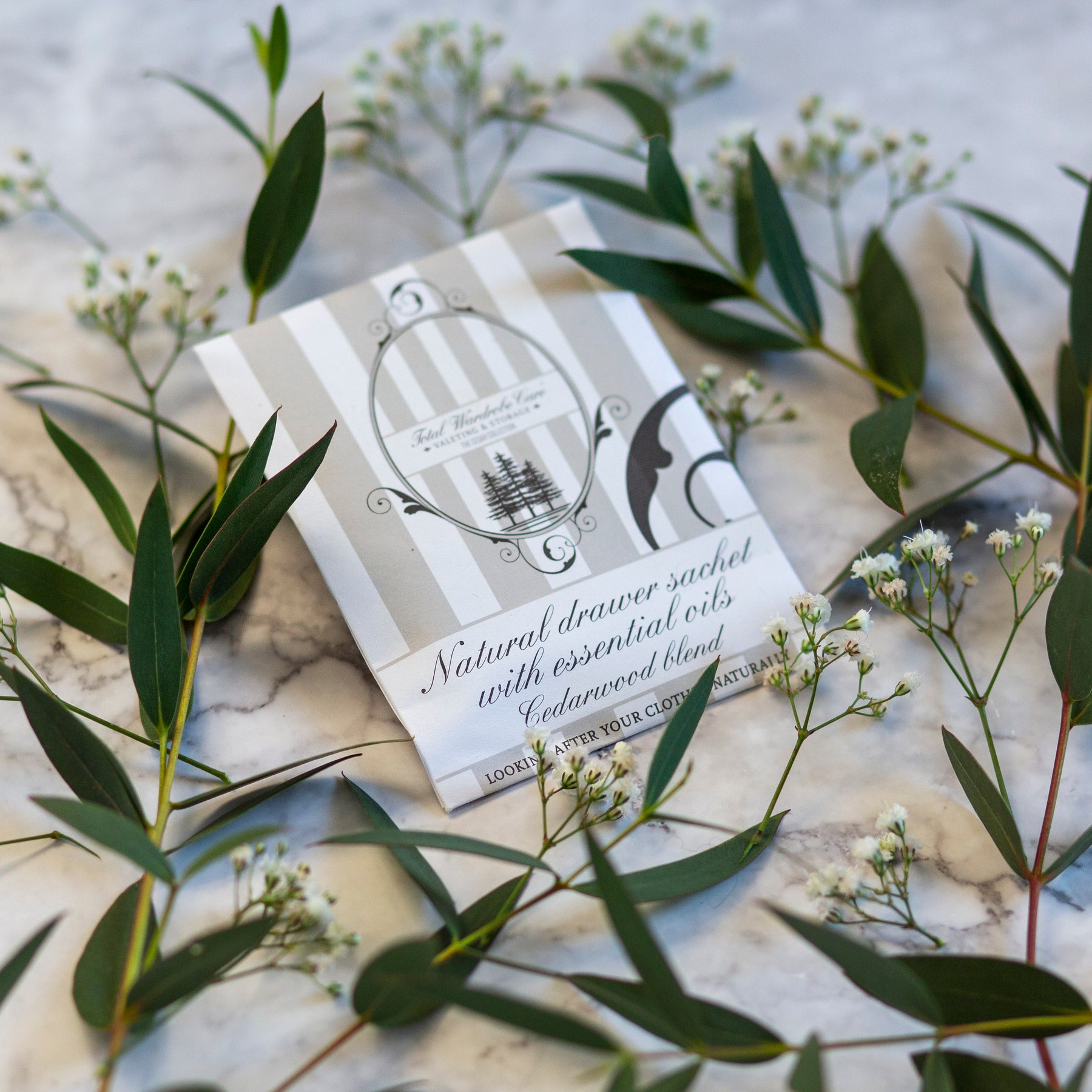 Cedarwood blend drawers sachet on marble surface among small white flowers