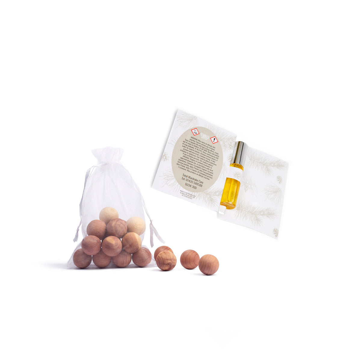 Closed organza bag with cedarwood balls inside and open packaging with refresher spray to centre