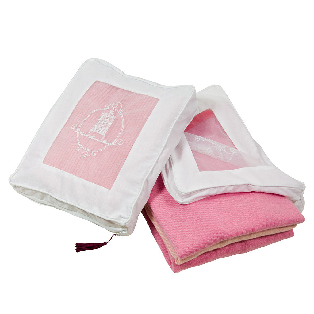 Cashmere storage bags one open and one closed with pink cashmere to the inside