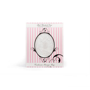 Cashmere storage bag inside pink and white packaging on white background