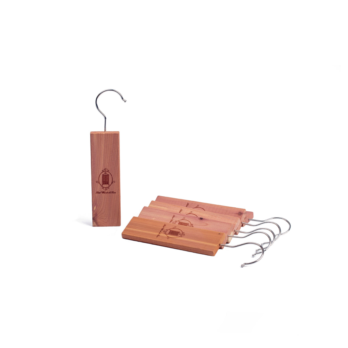 Singular cedarwood hanger standing beside a row of laying down hangers on white background