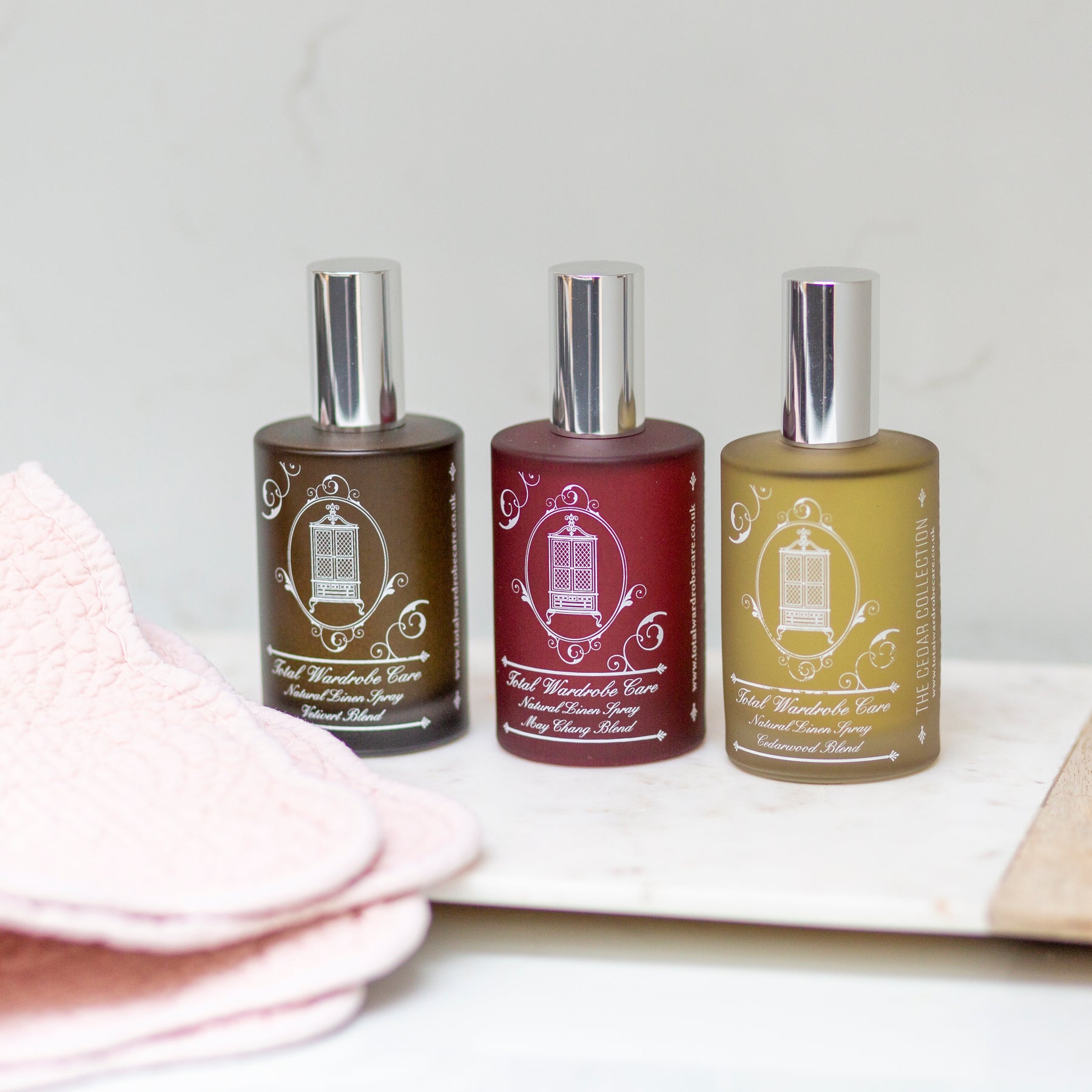 Total Wardrobe Care linen sprays lined up with all 3 scents. Vetivert, May Chang and Cedarwood 