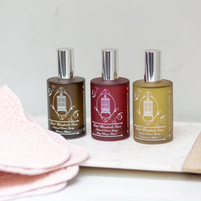 Total Wardrobe Care linen sprays lined up with all 3 scents. Vetivert, May Chang and Cedarwood 